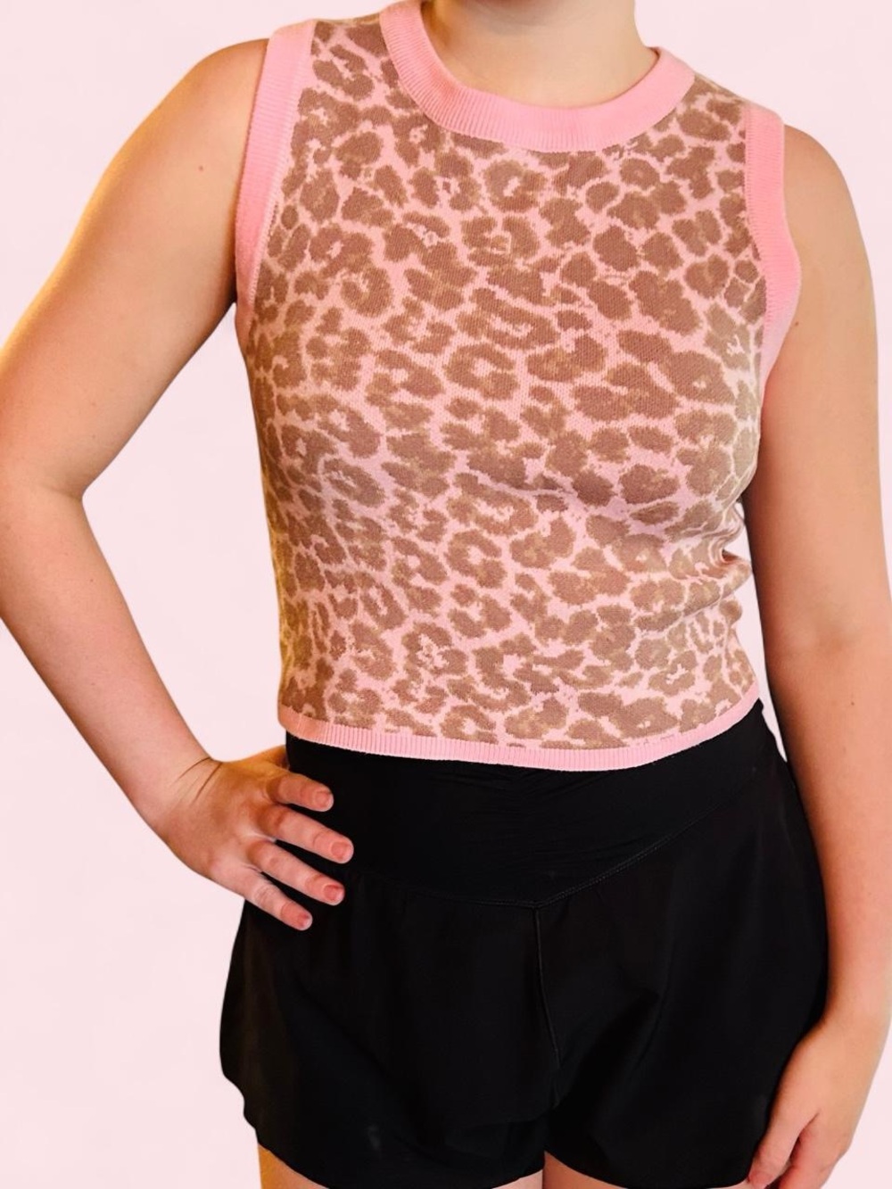 Entro sleeveless sweater vest featuring leopard print and a pink trim